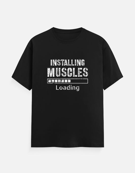 Black unisex t-shirt with "Installing Muscles Loading" text and progress bar graphic – funny workout and fitness apparel by Teetanic.